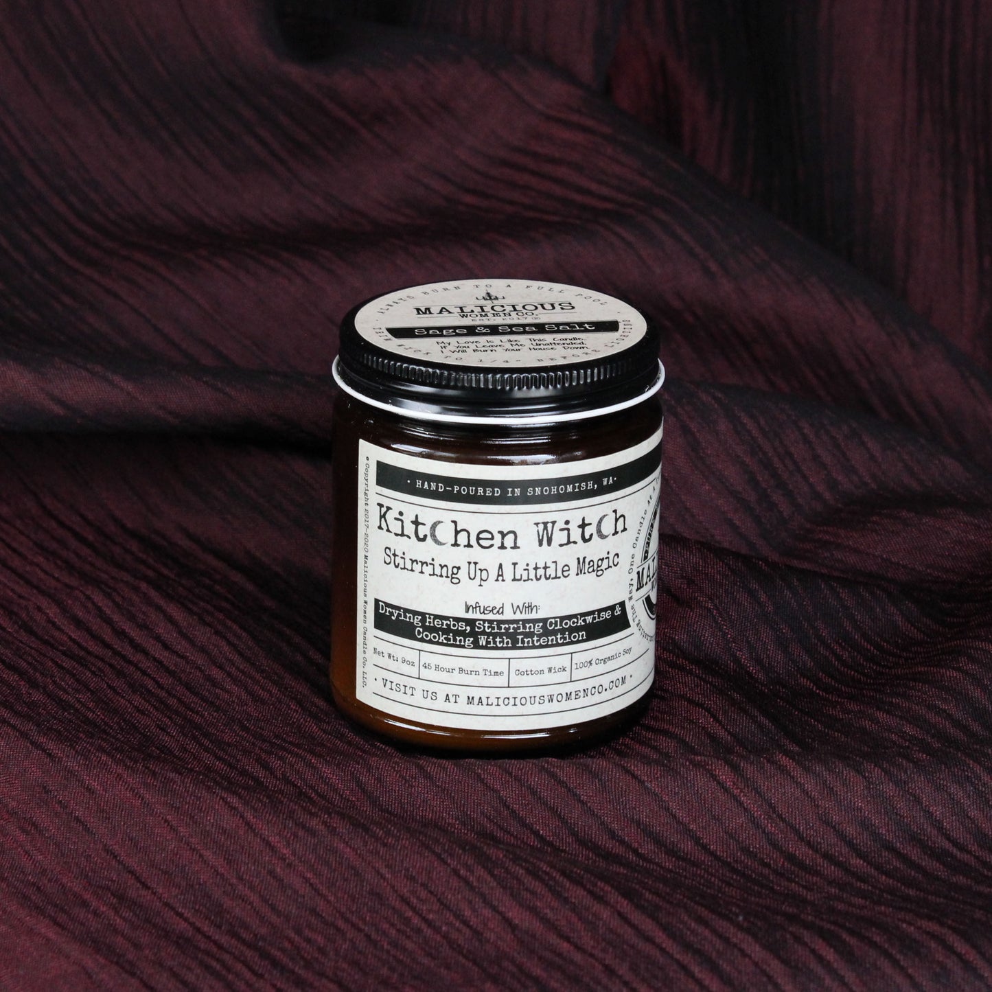 Kitchen witch candle infused with drying herbs, stirring clockwise and cooking with intentions.  Malicious Women Co.